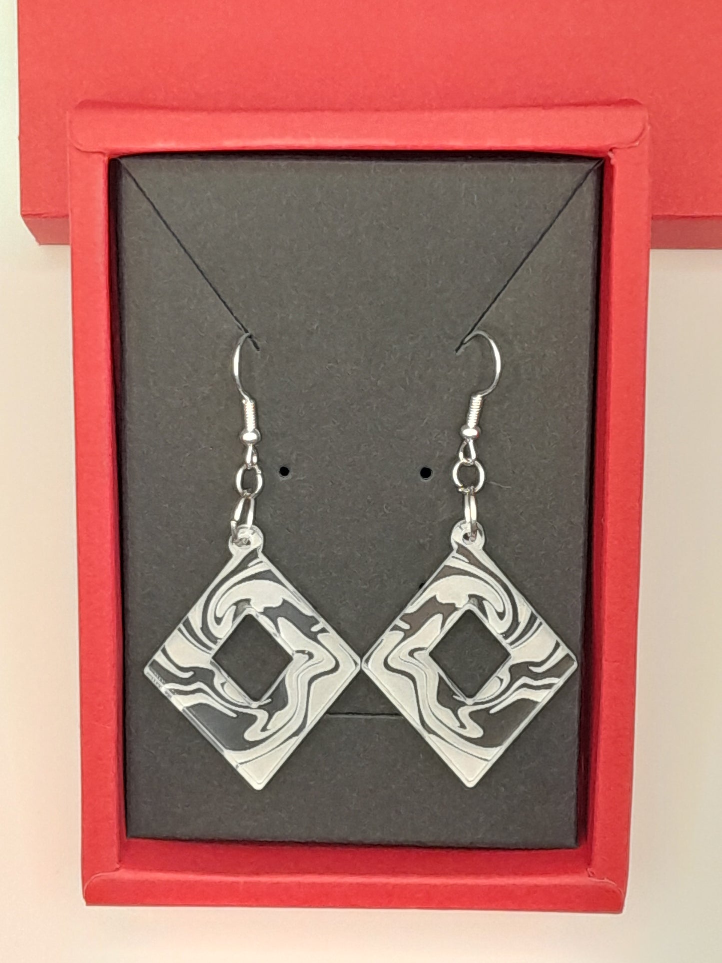 Acrylic diamond cutout swirl earrings